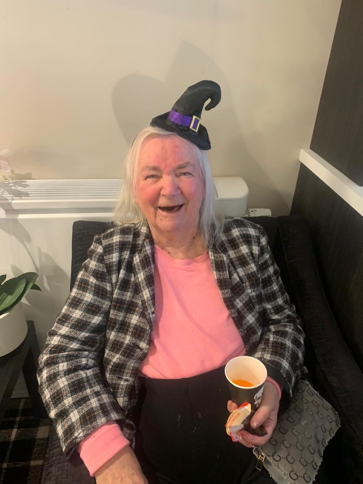 Resident Wearing Witch Hat & Enjoying a Drink
