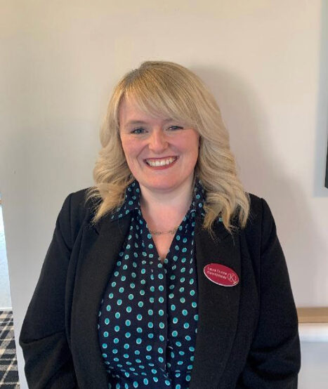 blonde woman with polka dot shirt smiling