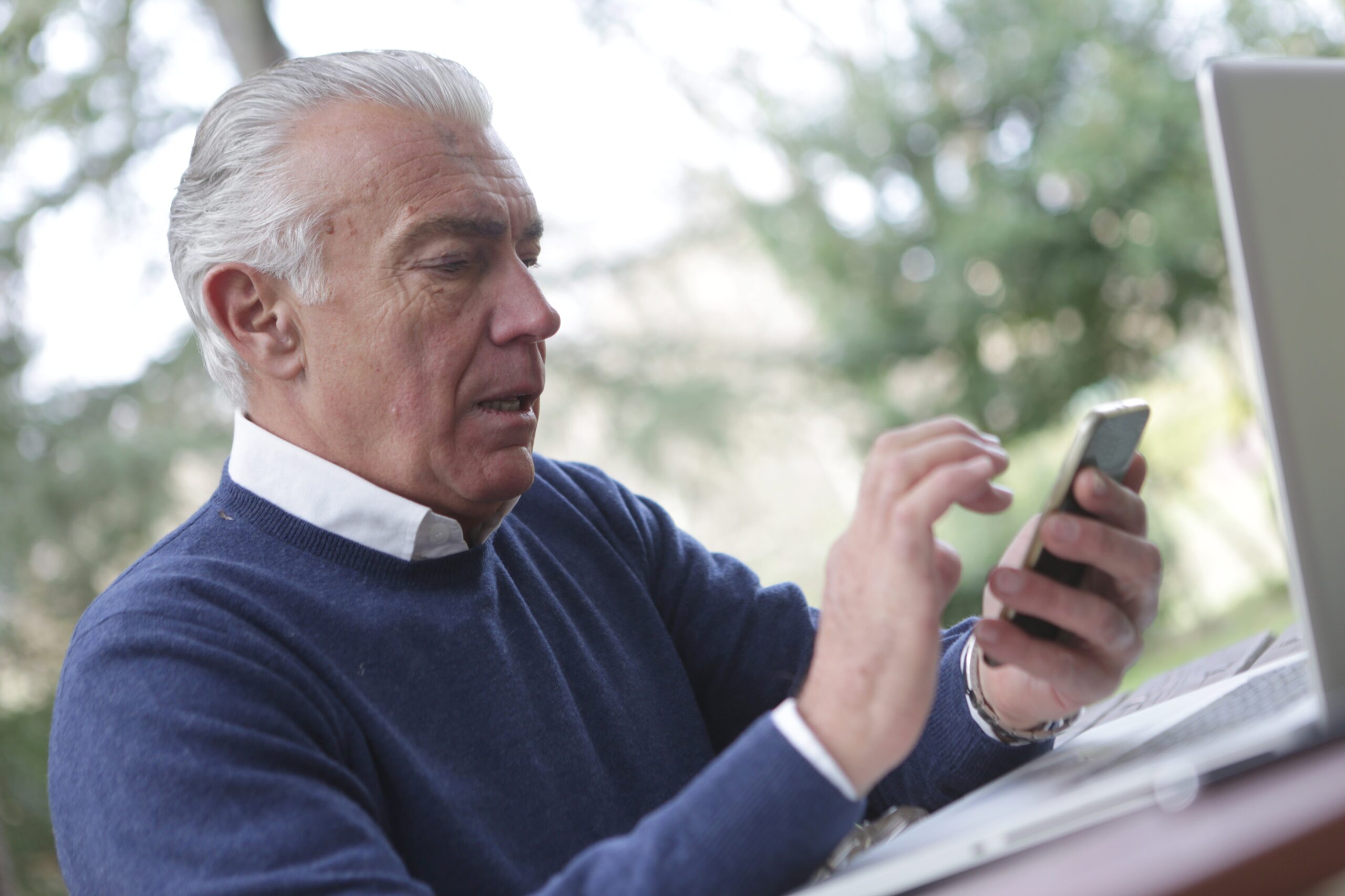 Elderly Gentleman Typing on Mobile Phone