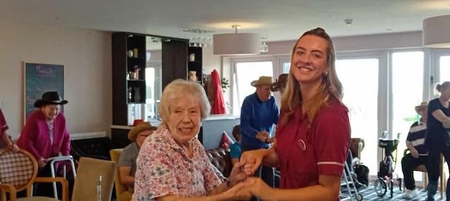 resident-and-care-assistant-dancing