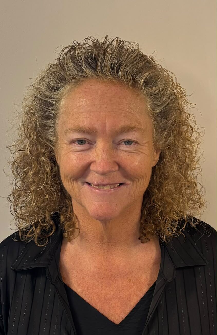 woman with curly hair smiling