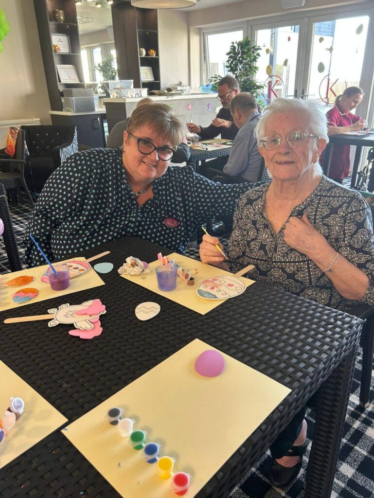 resident smiles with a loved one