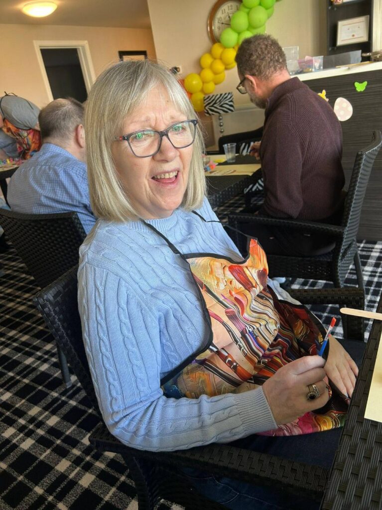 elderly woman smiling in apron