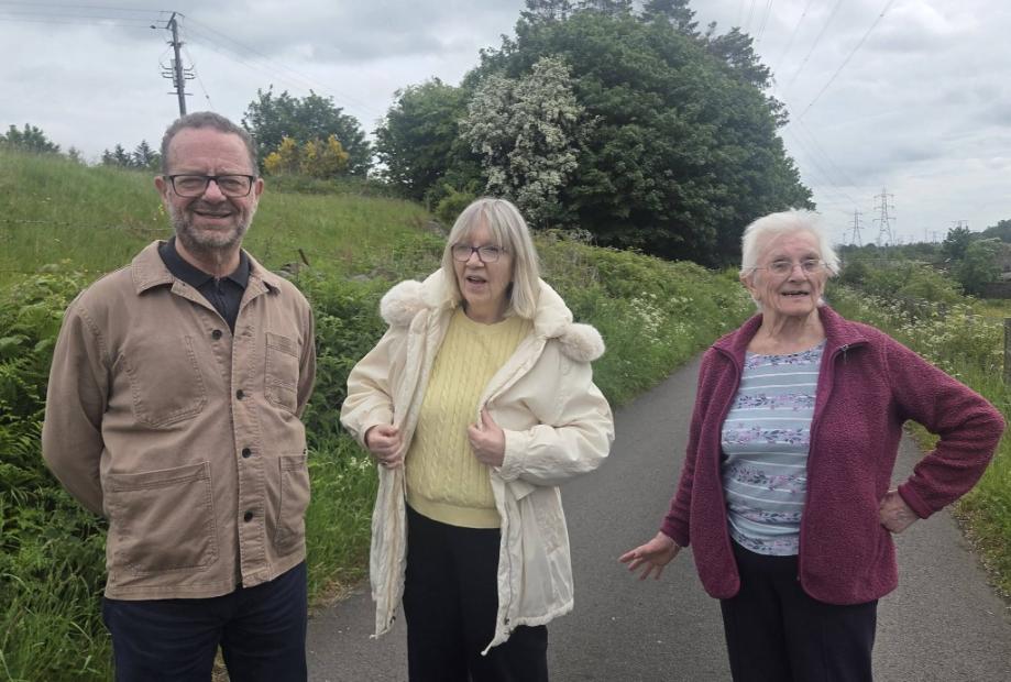 older adults standing outside by a field