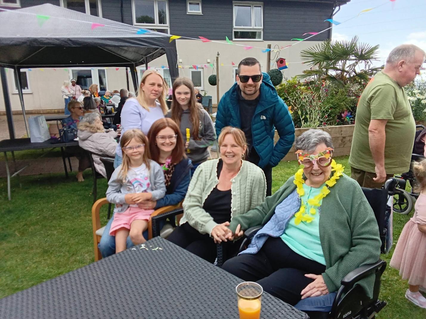 family smiling at care home summer fete