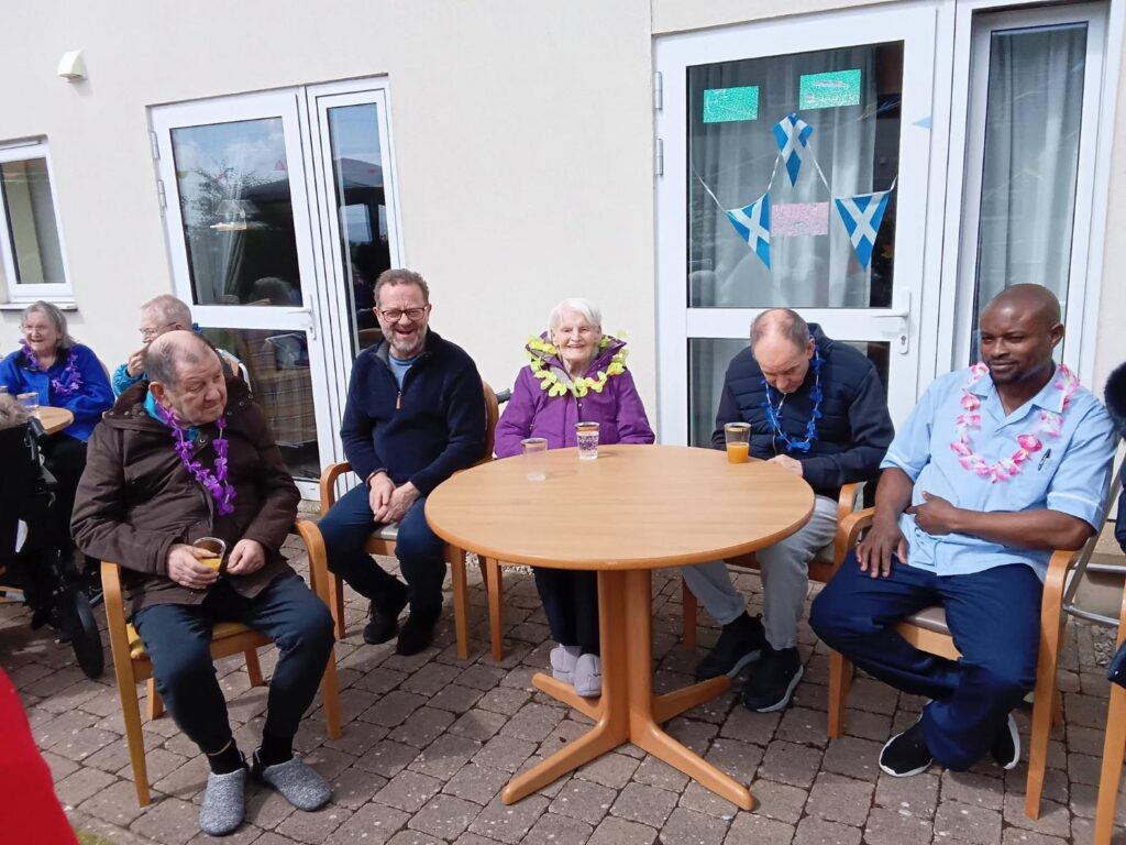 family smiling at care home summer fete