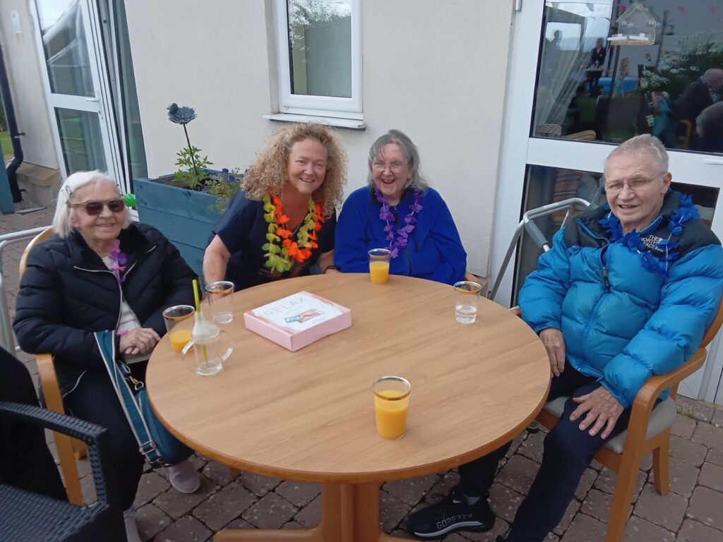 family smiling at care home summer fete