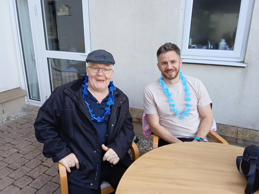family smiling at care home summer fete
