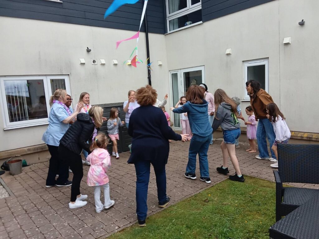 people standing in a circle for a summer fete game